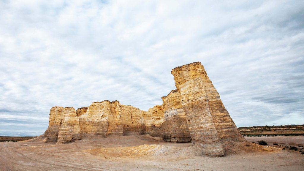 monument rocks in kansas, a large rock formation jutting out of nowhere