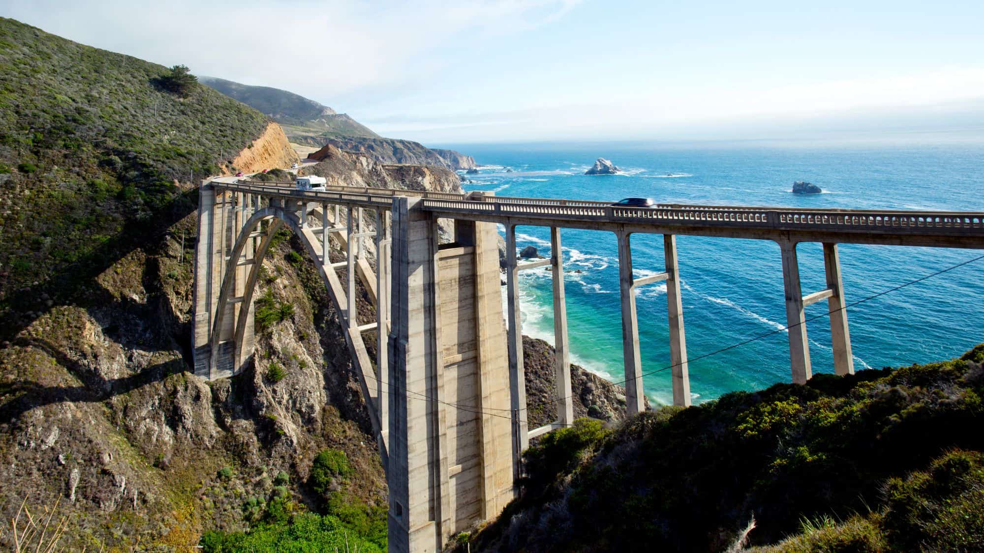 The famous bridge along Big Sur Coast Highway high above the valley below next to the ocean.