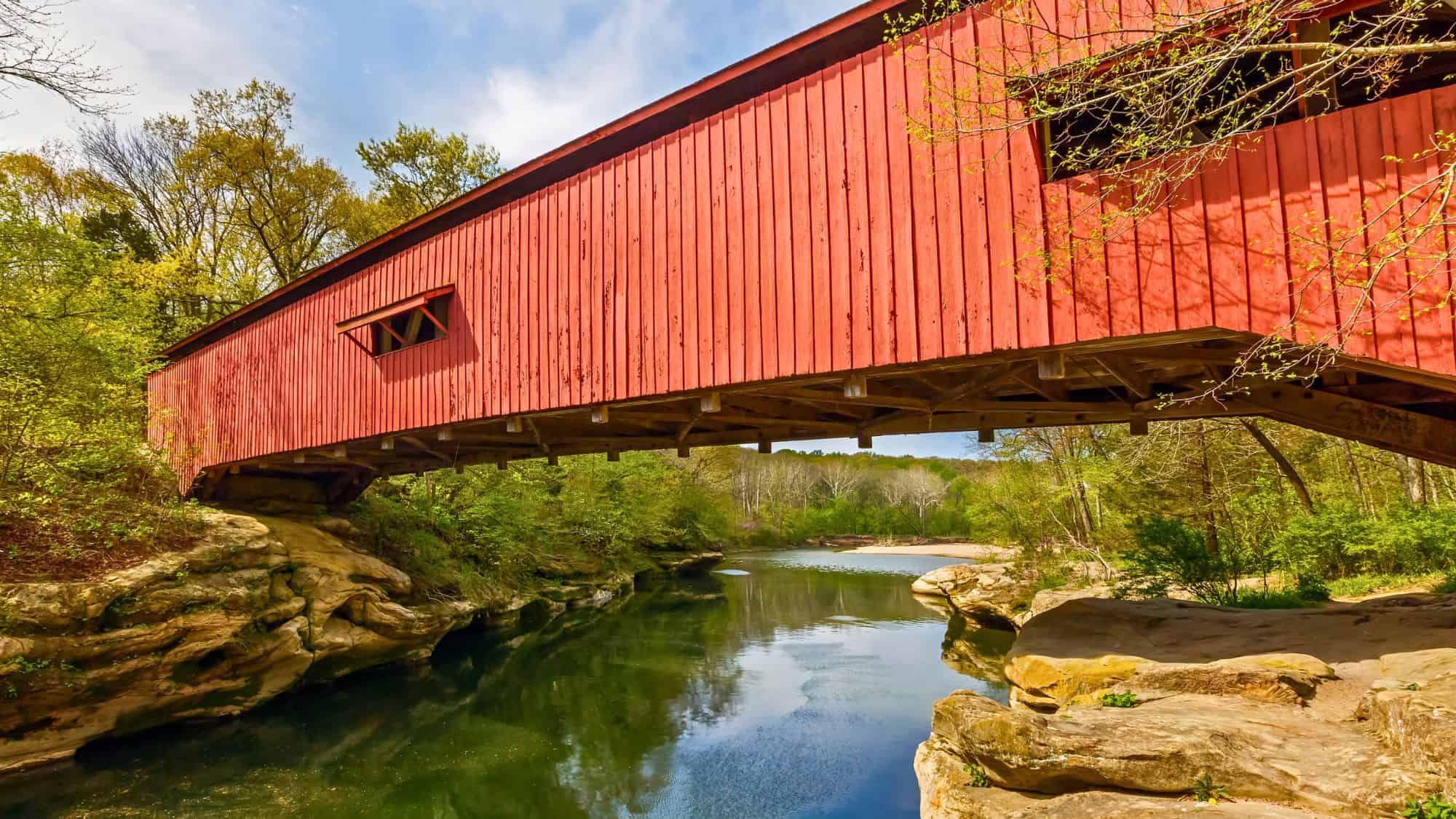 The Narrows Covered Bridge crosses Sugar Creek at the eastern edge of Turkey Run State Park in Parke County, Indiana, and is a single span Burr arch truss covered bridge structure.